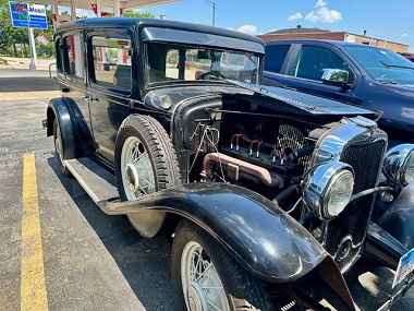 Vintage 1931 black truck in parking lot after service at Batavia Avenue Mobil in Batavia, IL