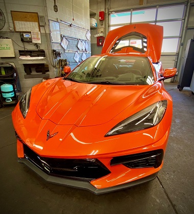 Orange and black corvette in service garage at Batavia Avenue Mobil in Batavia, IL